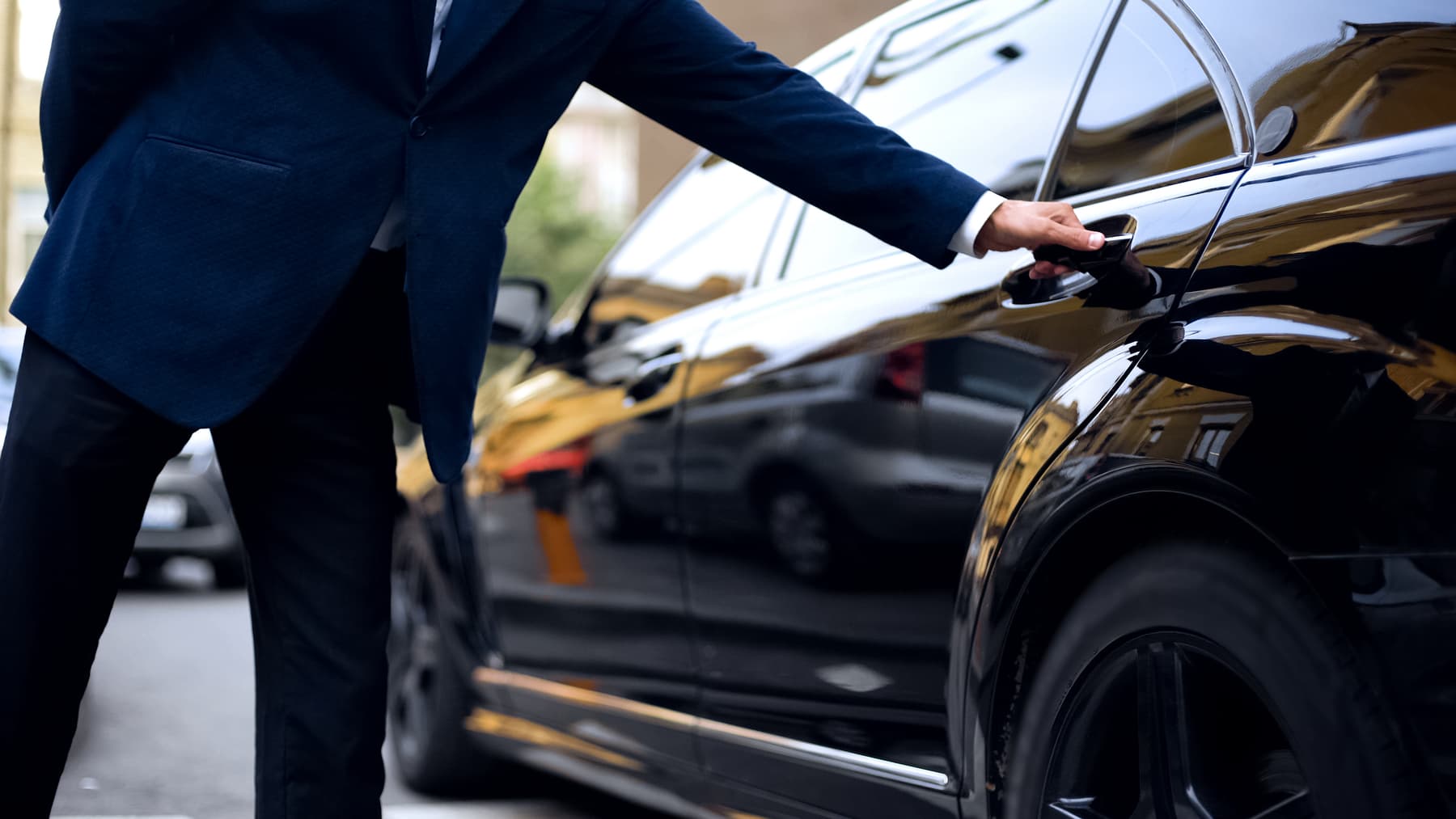 Driver opening rear door of car. Driver opening rear door of car.